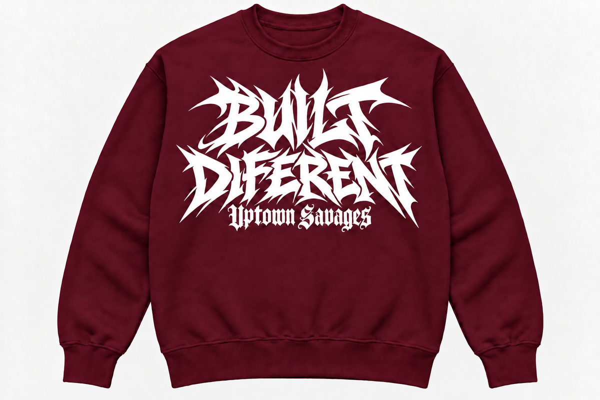 UPTOWN SAVAGES Built Diferent burgundy crewneck sweatshirt with white graffiti lettering on the front